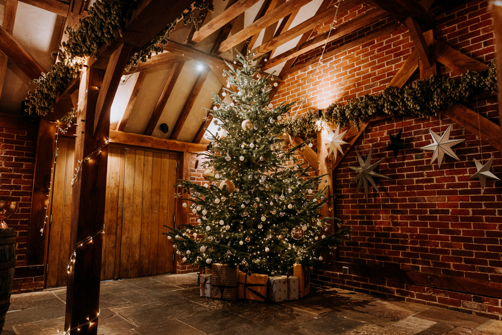 A beautifully decorated Christmas tree in The Ferry House's Oak Barn