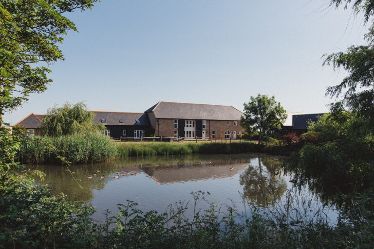 The Mocketts Farm Cottages overlooking the duck pond on a sunny day