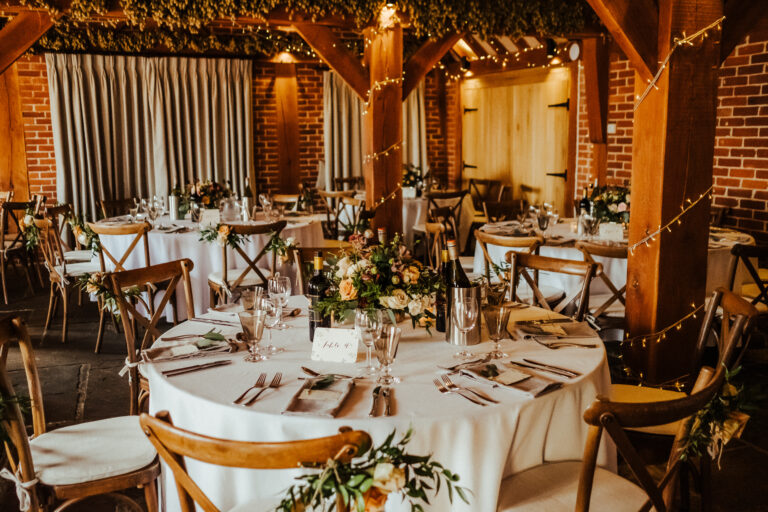 A beautiful rustic wedding breakfast in the wedding barn of The Ferry House in Kent
