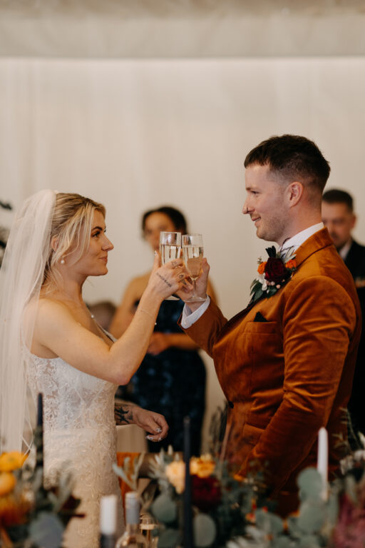 A bride and groom sharing a toast at their Kent wedding at The Ferry House.