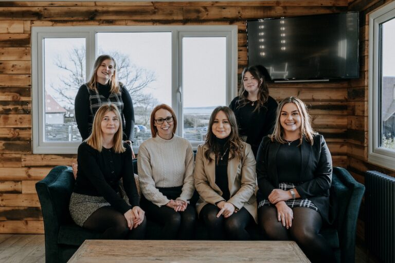 The Ferry House wedding team in a group photo in the Garden Lodge