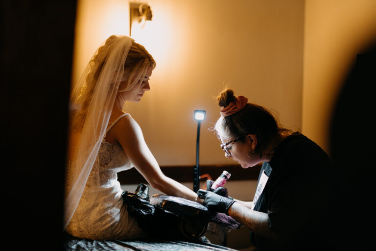 A bride getting a tattoo on her wedding day at The Ferry House in Kent.