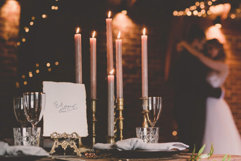 A couple dancing behind their top table at their winter wedding at The Ferry House in Kent.