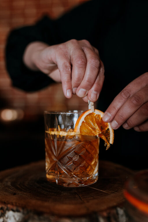 An Old Fashioned cocktail being prepared on a whisky station at winter wedding venue The Ferry House.