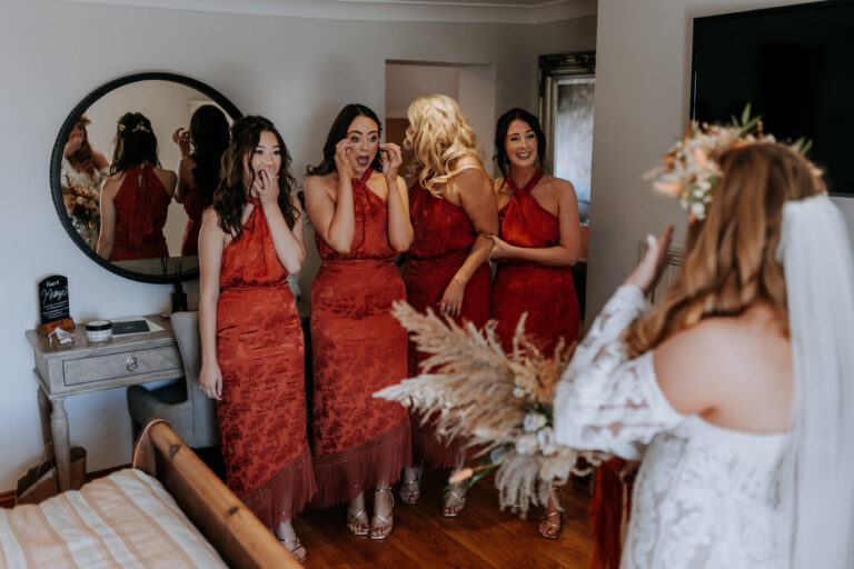 A bride's dress reveal to her bridesmaids