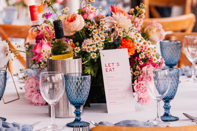 Bold spring wedding theme on wedding breakfast tables at the Kent wedding venue The Ferry House.