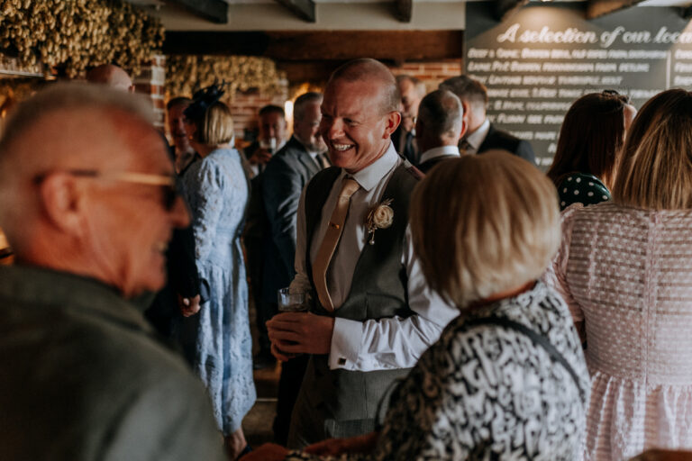 Wedding guests enjoying a pub drinks reception