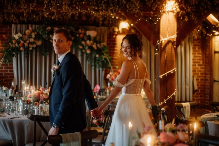 A couple walking through the Hop Barn at The Ferry House in Kent.