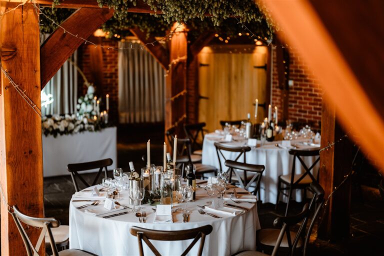 A wedding breakfast set up in the Hop Barn at Kent wedding venue The Ferry House.