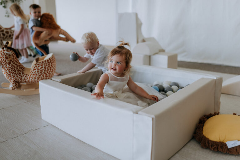 Children playing in a ball pit at a christening