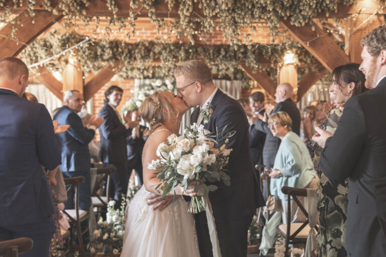 A spring wedding ceremony in the Hop Barn at Kent wedding venue The Ferry House.